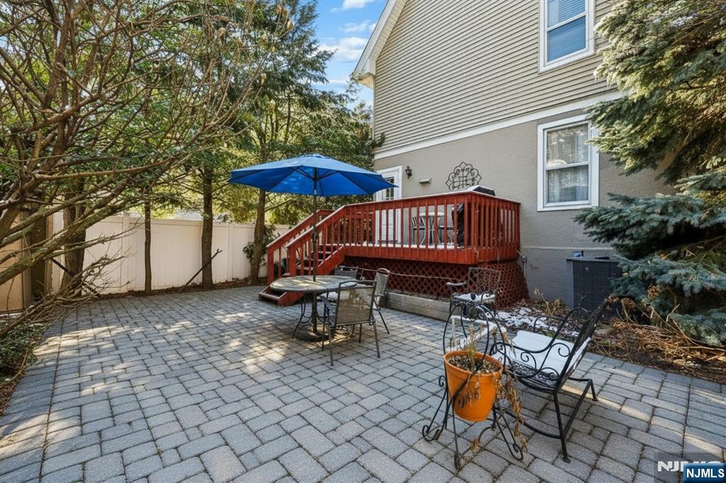 133 Hudson Avenue Ridgefield Park, NJ 07660 - Photo 14 of 14 a view of a patio with table and chairs under an umbrella