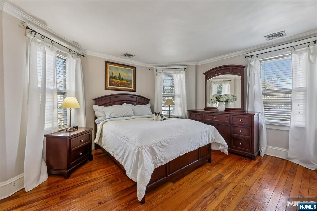 133 Hudson Avenue Ridgefield Park, NJ 07660 - Photo 8 of 14 a bedroom with a bed and wooden floor