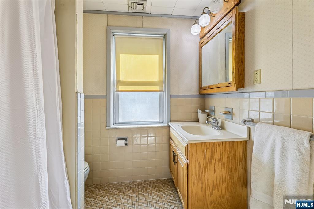 133 Hudson Avenue Ridgefield Park, NJ 07660 - Photo 9 of 14 a bathroom with a sink a toilet and a shower