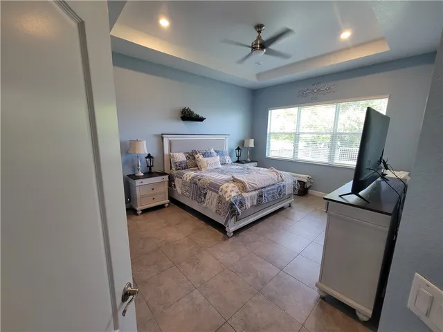 a bedroom with a bed window and a couch