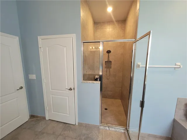 a view of a hallway with wooden floor and stairs