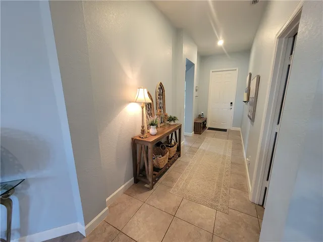 a bedroom with a bed a mirror and dresser