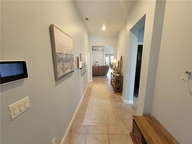 a hallway with a view of bedroom with a large window