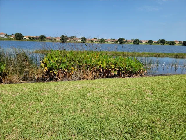 a view of a chair and table in the garden