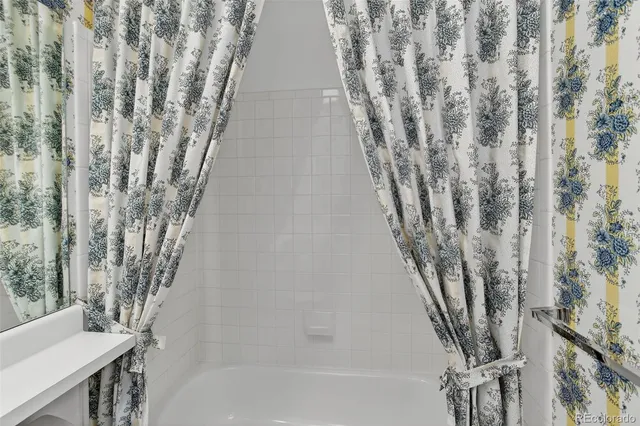 a bedroom with a bed and a painting