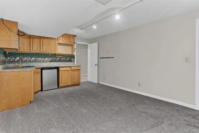 a kitchen with stainless steel appliances granite countertop a stove and a refrigerator