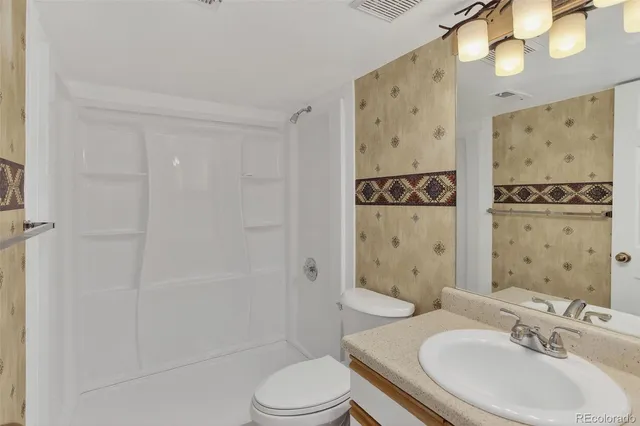 a bedroom with furniture and a flat screen tv