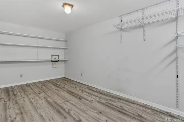 a view of walk in closet with clothes and shoes