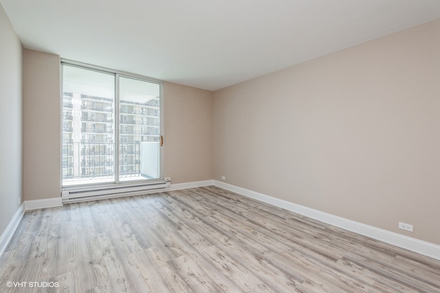 6033 North Sheridan Road, Unit 31E Chicago, IL 60660 - Photo 12 of 15 wooden floor in an empty room with a window