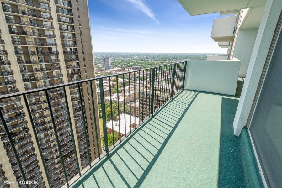 6033 North Sheridan Road, Unit 31E Chicago, IL 60660 - Photo 14 of 15 a view of balcony with wooden floor