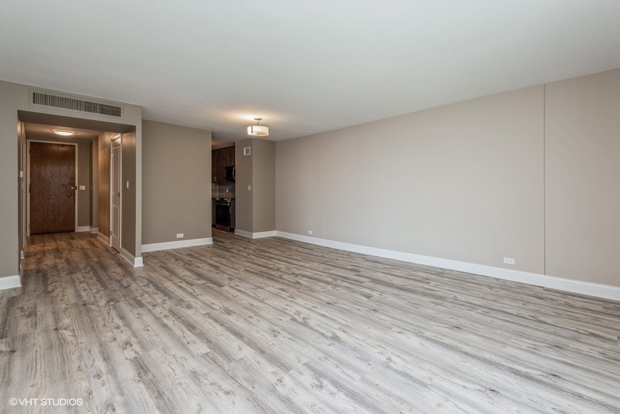 6033 North Sheridan Road, Unit 31E Chicago, IL 60660 - Photo 5 of 15 a view of an empty room and wooden floor