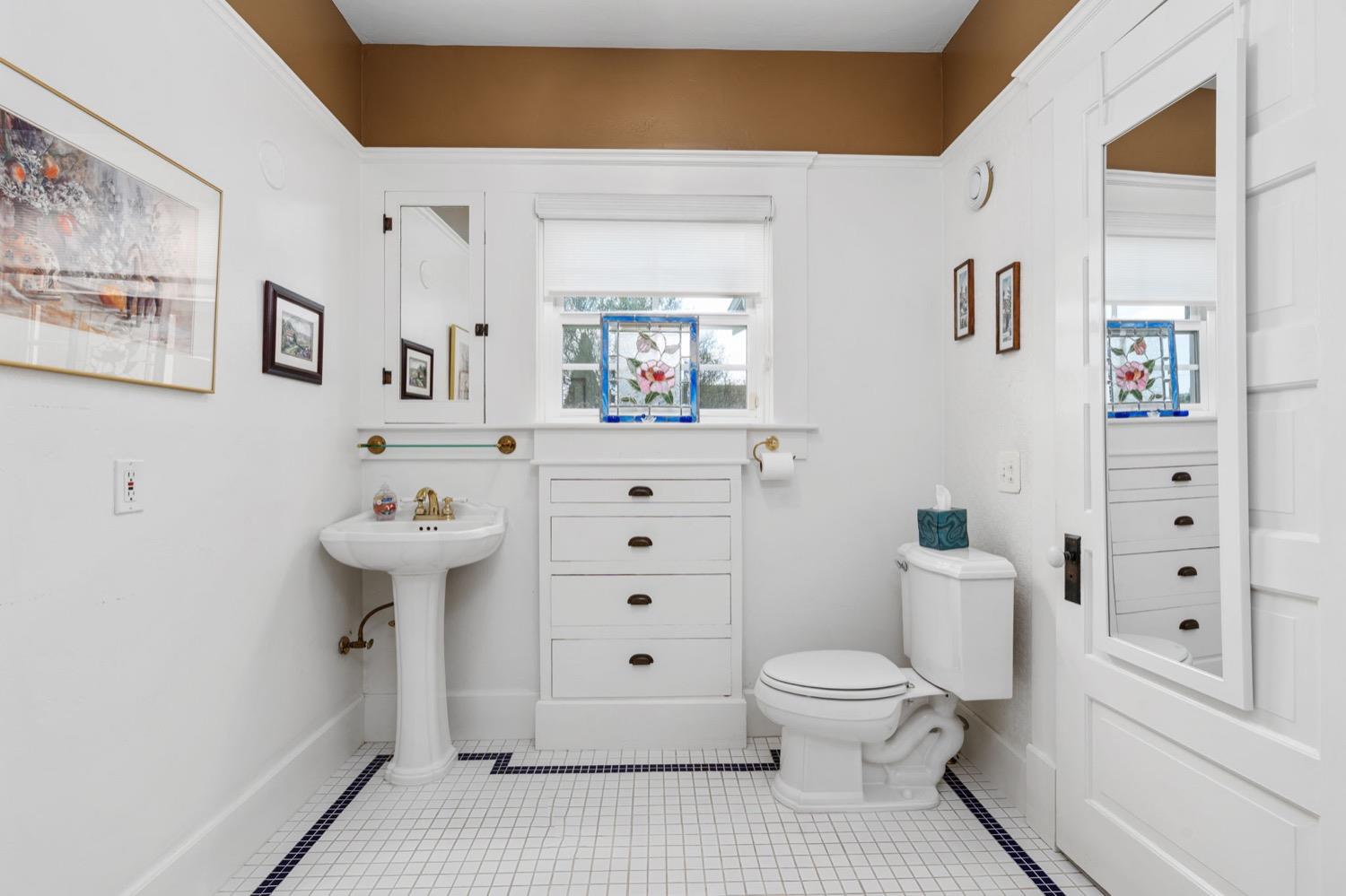 406 Oxford Avenue Clovis, CA 93612 - Photo 44 of 89 a white toilet sitting next to a bathroom sink