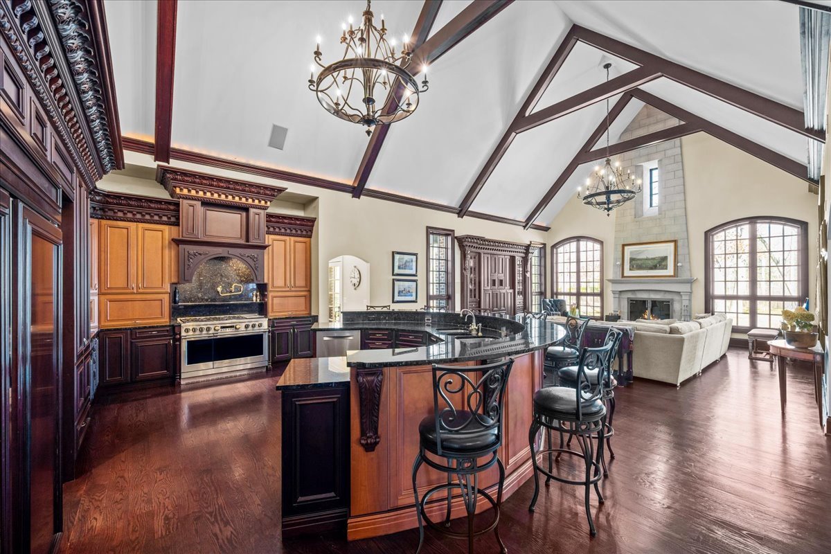 936 Ringwood Road Lake Forest, IL 60045 - Photo 23 of 58 a dining hall with stainless steel appliances granite countertop a stove and chairs with wooden floor