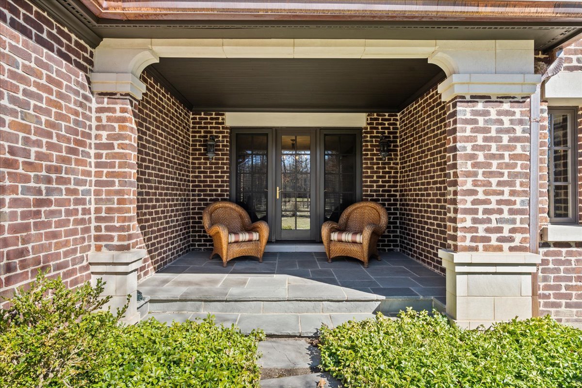 936 Ringwood Road Lake Forest, IL 60045 - Photo 29 of 58 a view of a patio with couple of couch in front of window