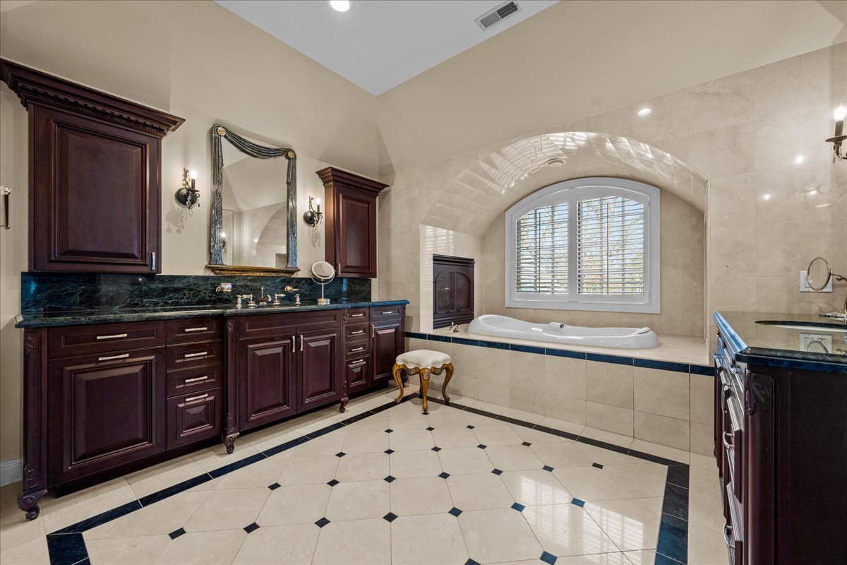 936 Ringwood Road Lake Forest, IL 60045 - Photo 34 of 58 a bathroom with a sink and a large mirror
