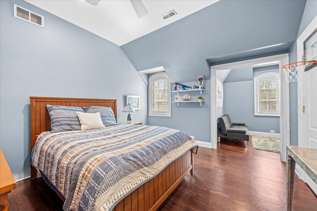 936 Ringwood Road Lake Forest, IL 60045 - Photo 38 of 58 a bedroom with a bed and wooden floor