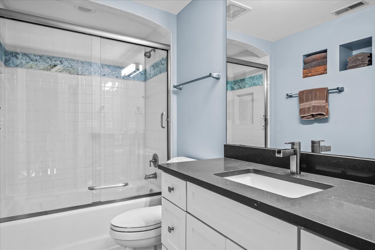 936 Ringwood Road Lake Forest, IL 60045 - Photo 40 of 58 a bathroom with a granite countertop sink toilet a large mirror a shower and a mirror