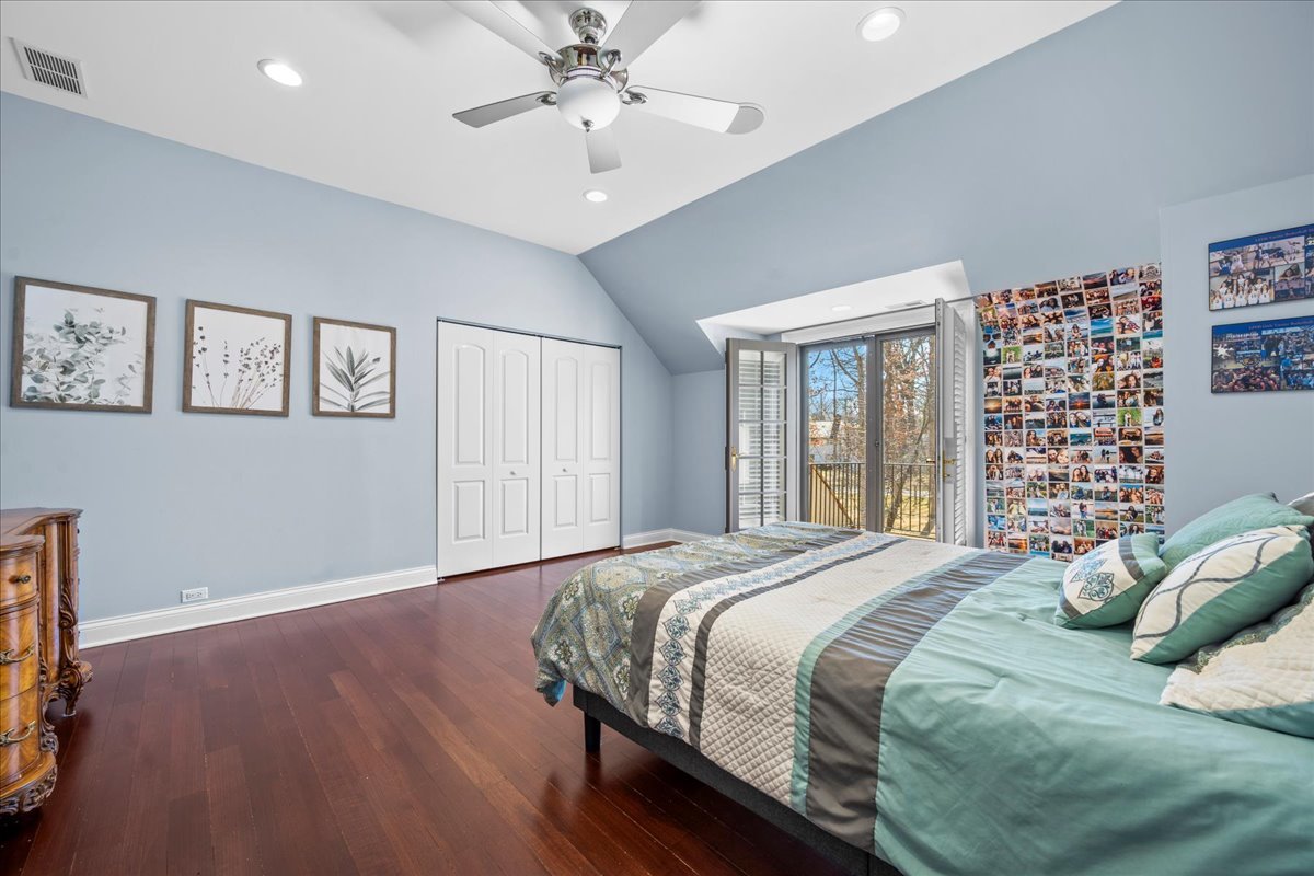 936 Ringwood Road Lake Forest, IL 60045 - Photo 41 of 58 a bedroom with a large bed and a chandelier