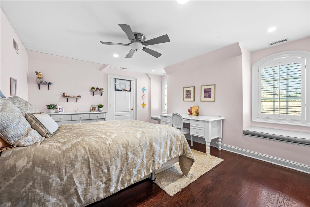 936 Ringwood Road Lake Forest, IL 60045 - Photo 43 of 58 a spacious bedroom with a bed a dresser and wooden floor