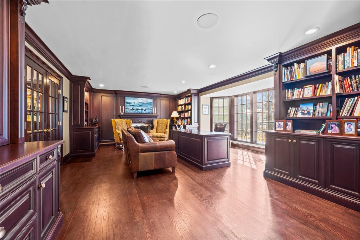 936 Ringwood Road Lake Forest, IL 60045 - Photo 5 of 58 a living room with fireplace furniture and a book shelf