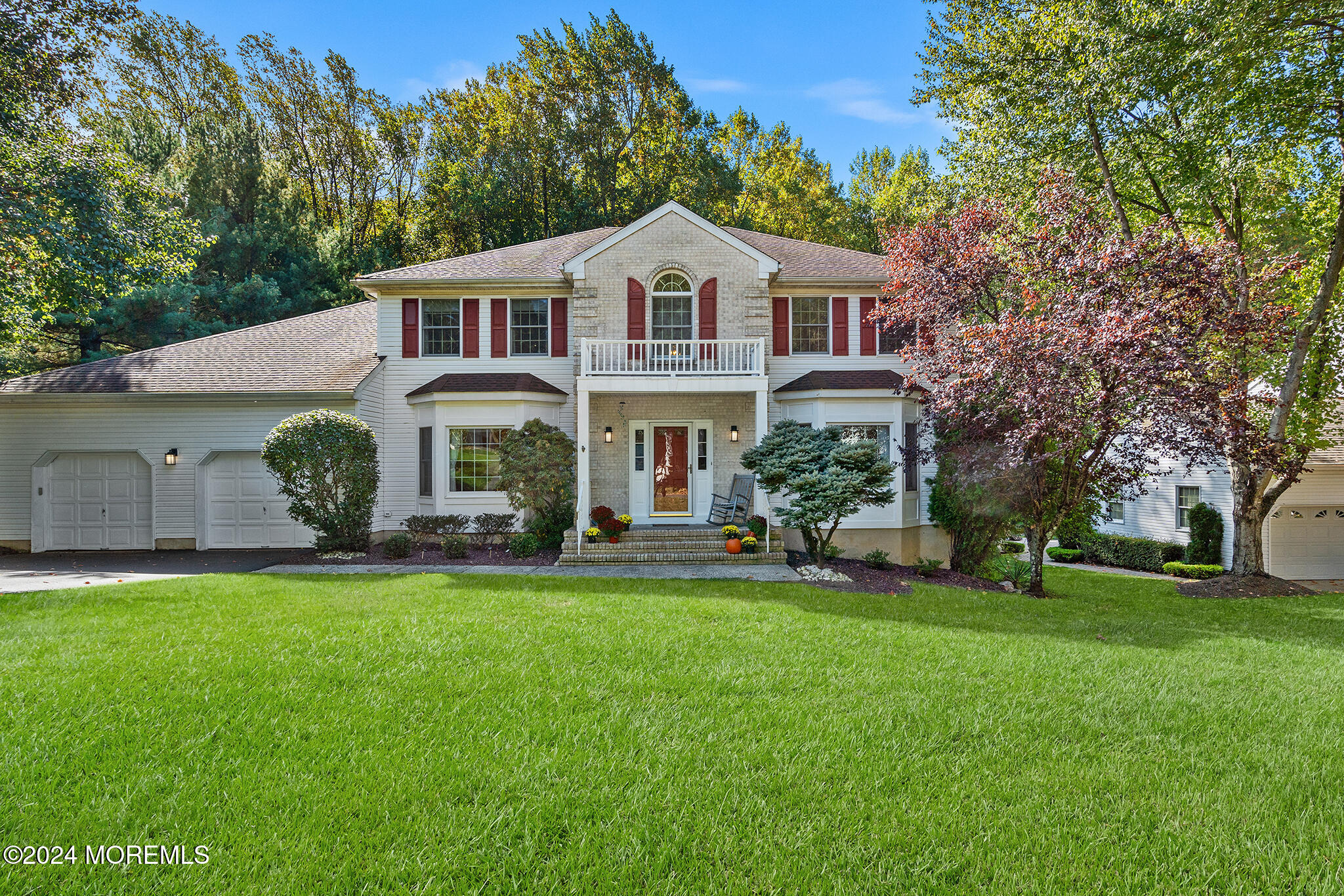 276 Nottingham Road Morganville, NJ 07751 - Photo 1 of 55 a front view of a house with a garden and trees
