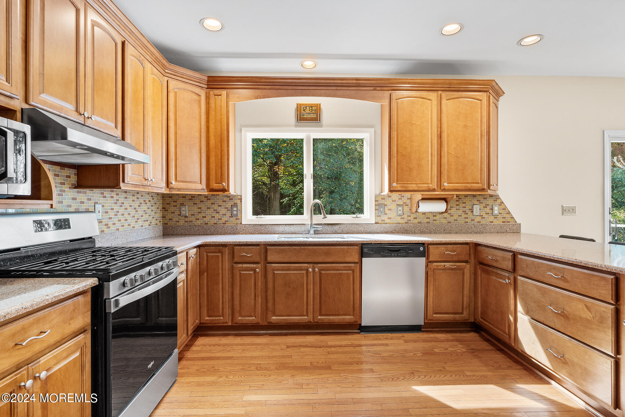 276 Nottingham Road Morganville, NJ 07751 - Photo 14 of 55 a kitchen with stainless steel appliances granite countertop a stove a sink and a microwave