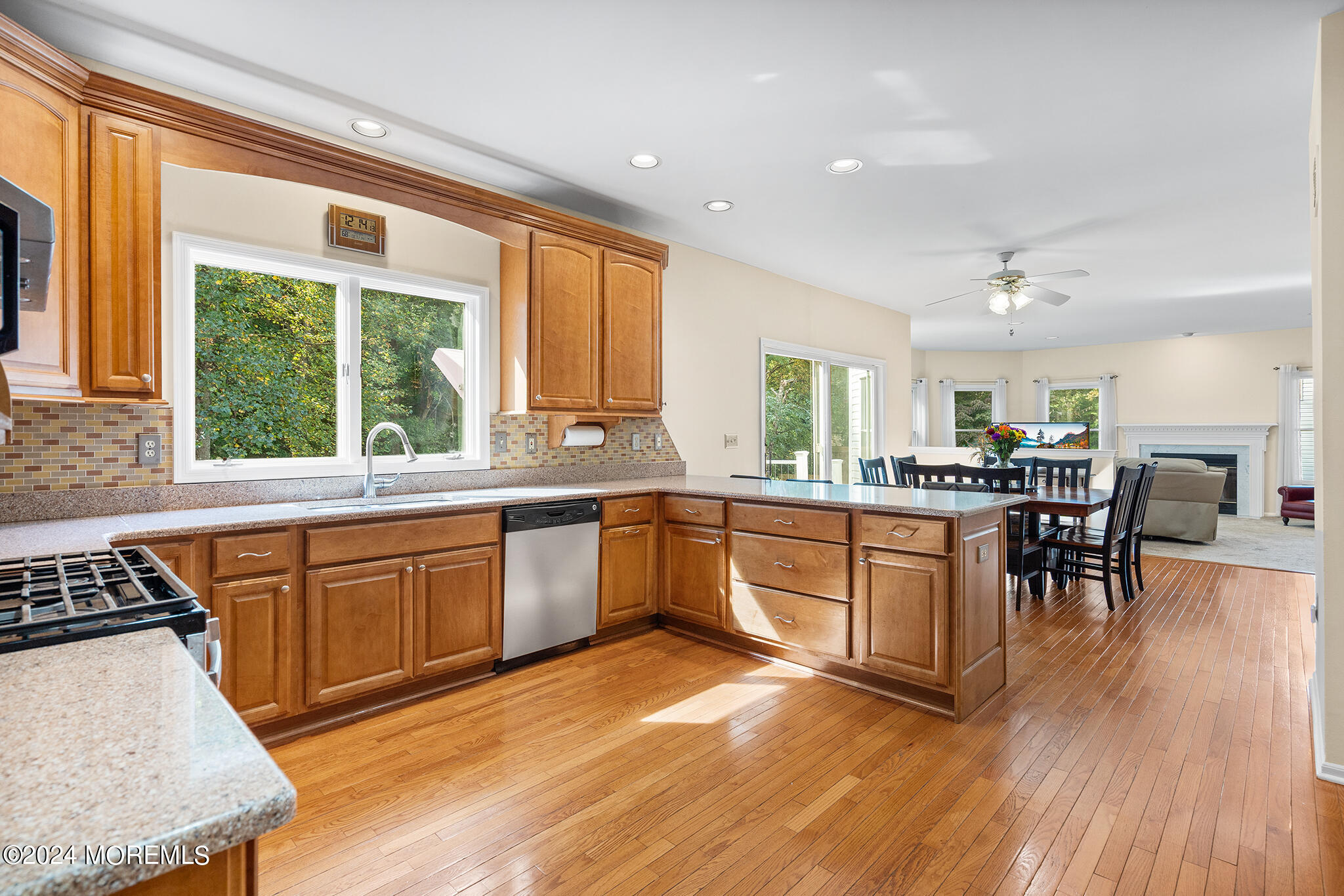 276 Nottingham Road Morganville, NJ 07751 - Photo 15 of 55 a kitchen with stainless steel appliances granite countertop wooden floors and white cabinets