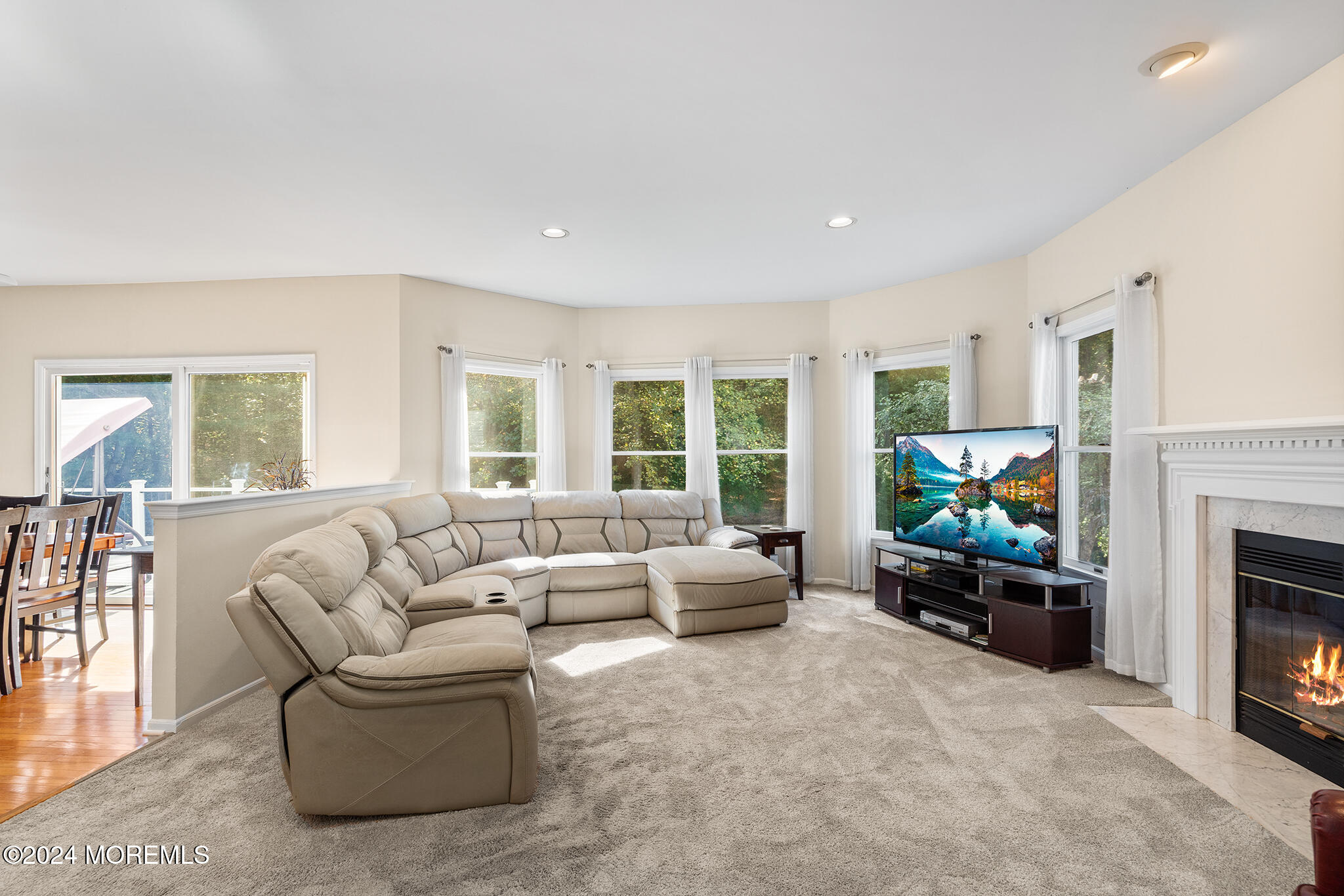 276 Nottingham Road Morganville, NJ 07751 - Photo 17 of 55 a living room with furniture a fireplace and a flat screen tv
