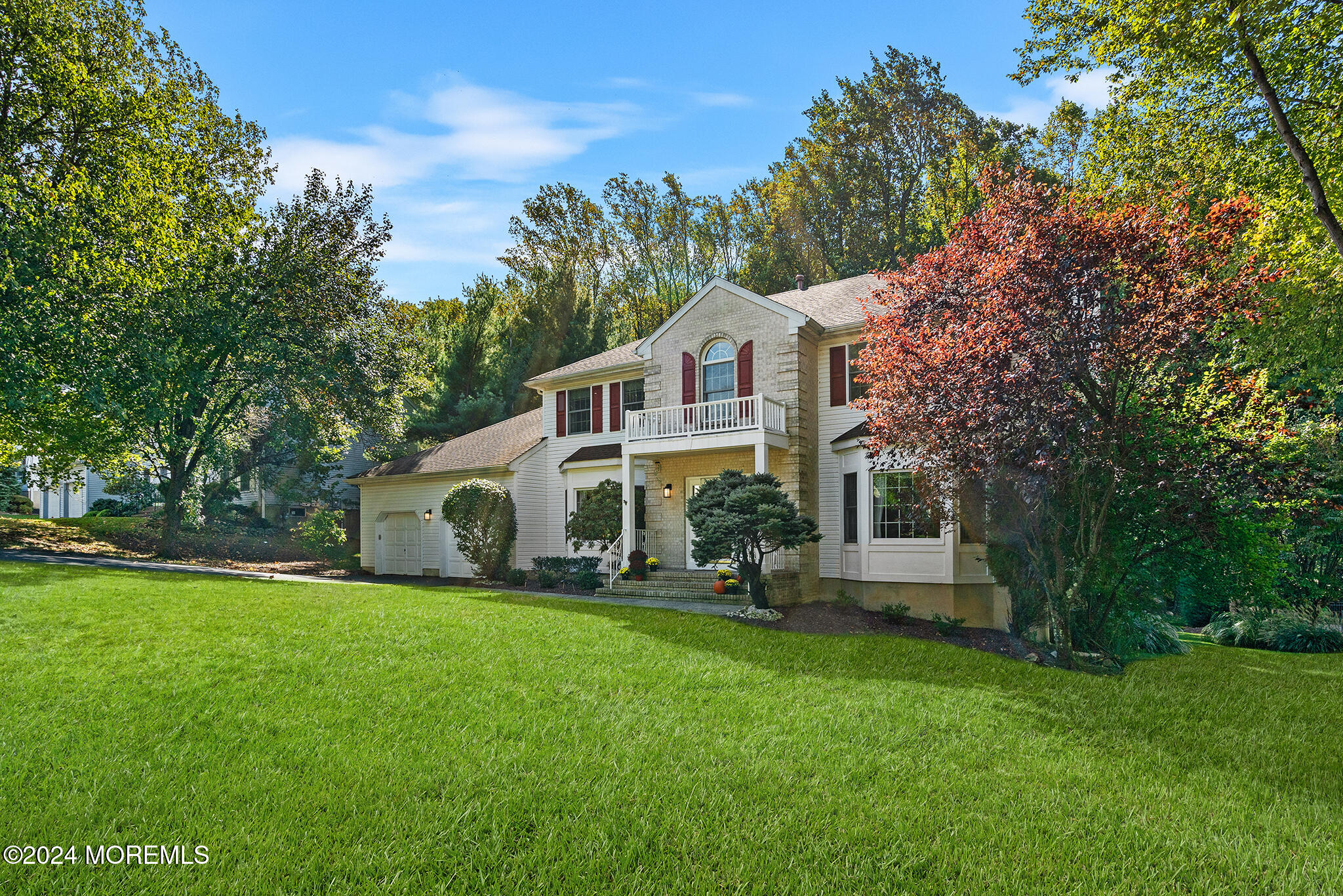 276 Nottingham Road Morganville, NJ 07751 - Photo 2 of 55 a front view of a house with a garden and trees