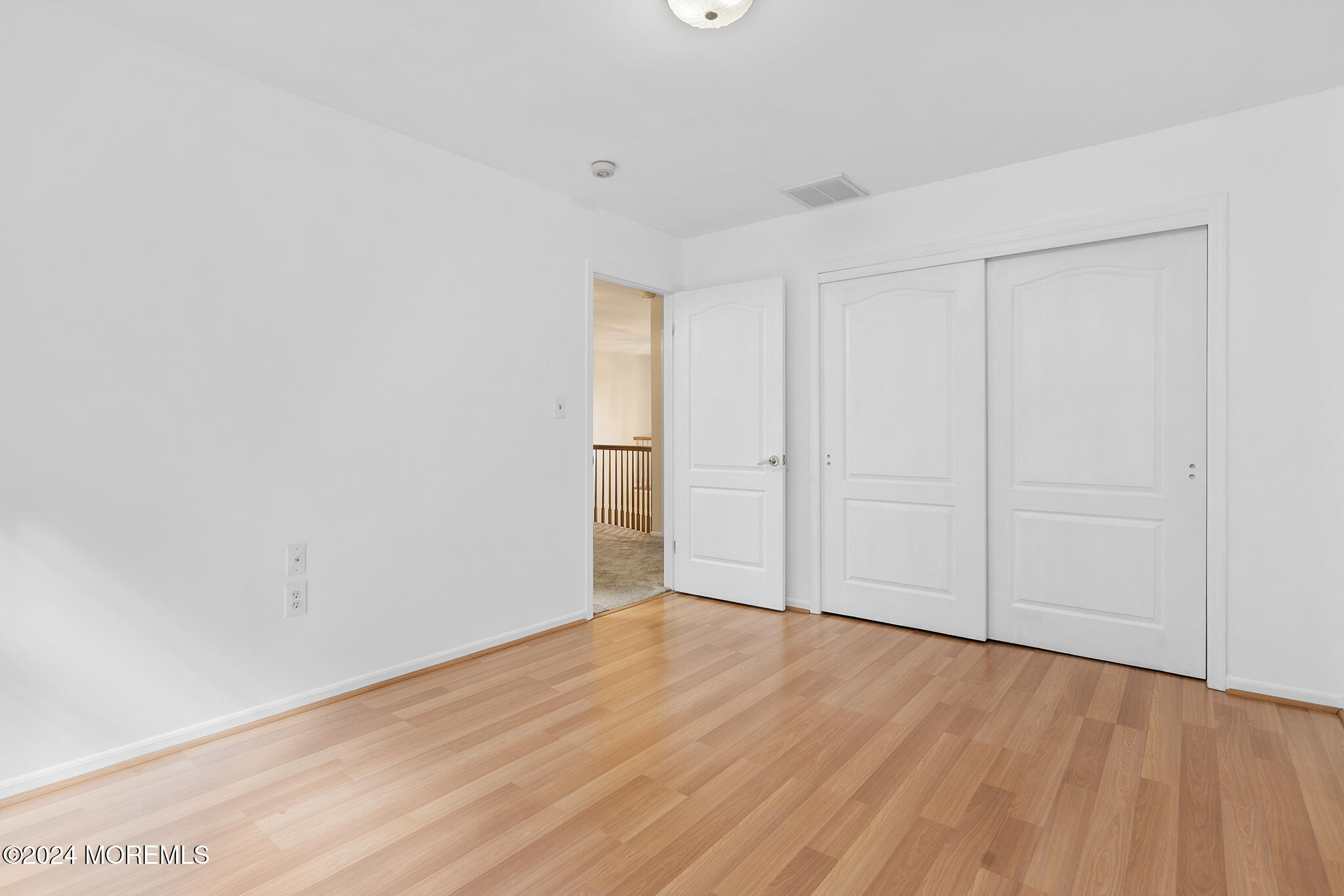 276 Nottingham Road Morganville, NJ 07751 - Photo 26 of 55 a view of an empty room with wooden floor