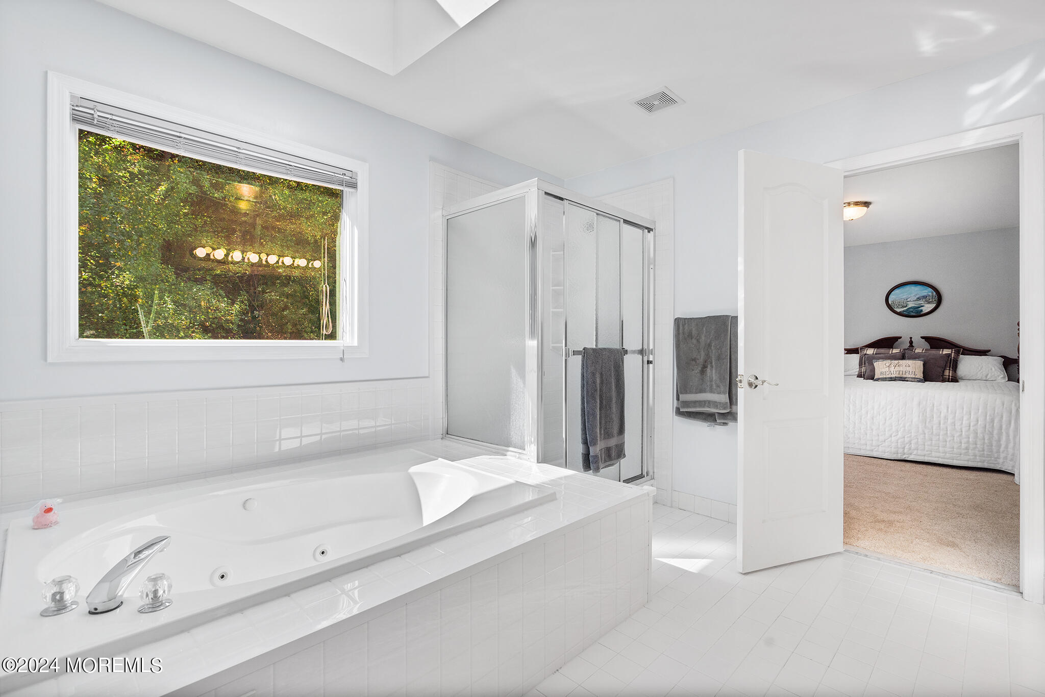 276 Nottingham Road Morganville, NJ 07751 - Photo 38 of 55 a bathroom with a tub a sink and a large mirror