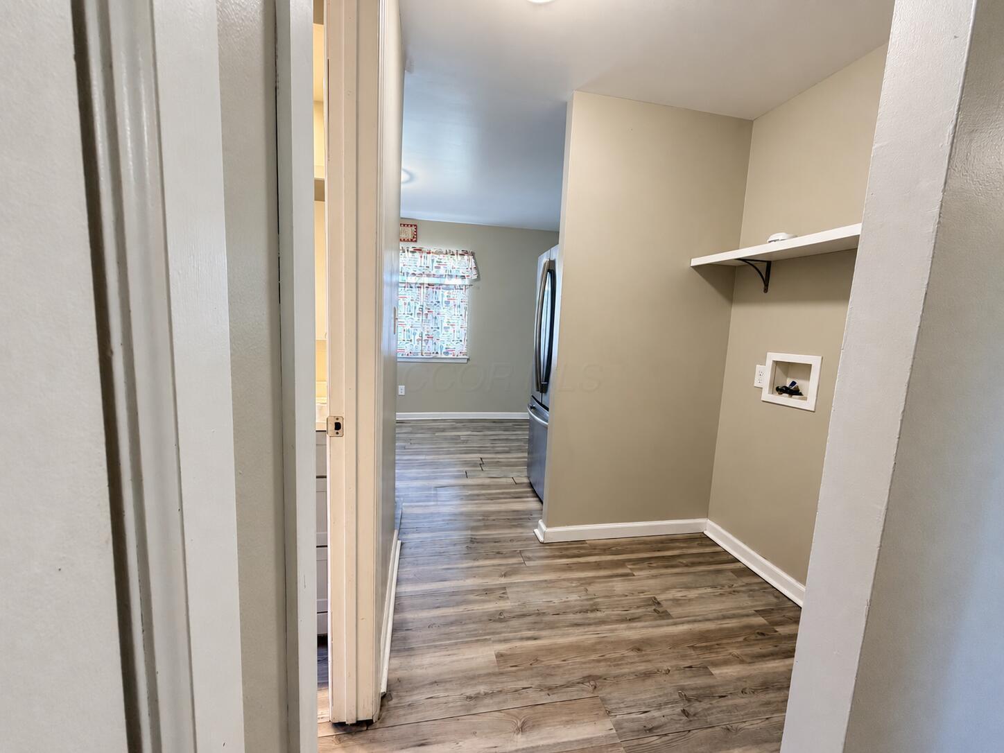 1769 Ward Road Columbus, OH 43224 - Photo 10 of 18 Dedicated laundry area with a wall-mounted shelf, utility hookups.