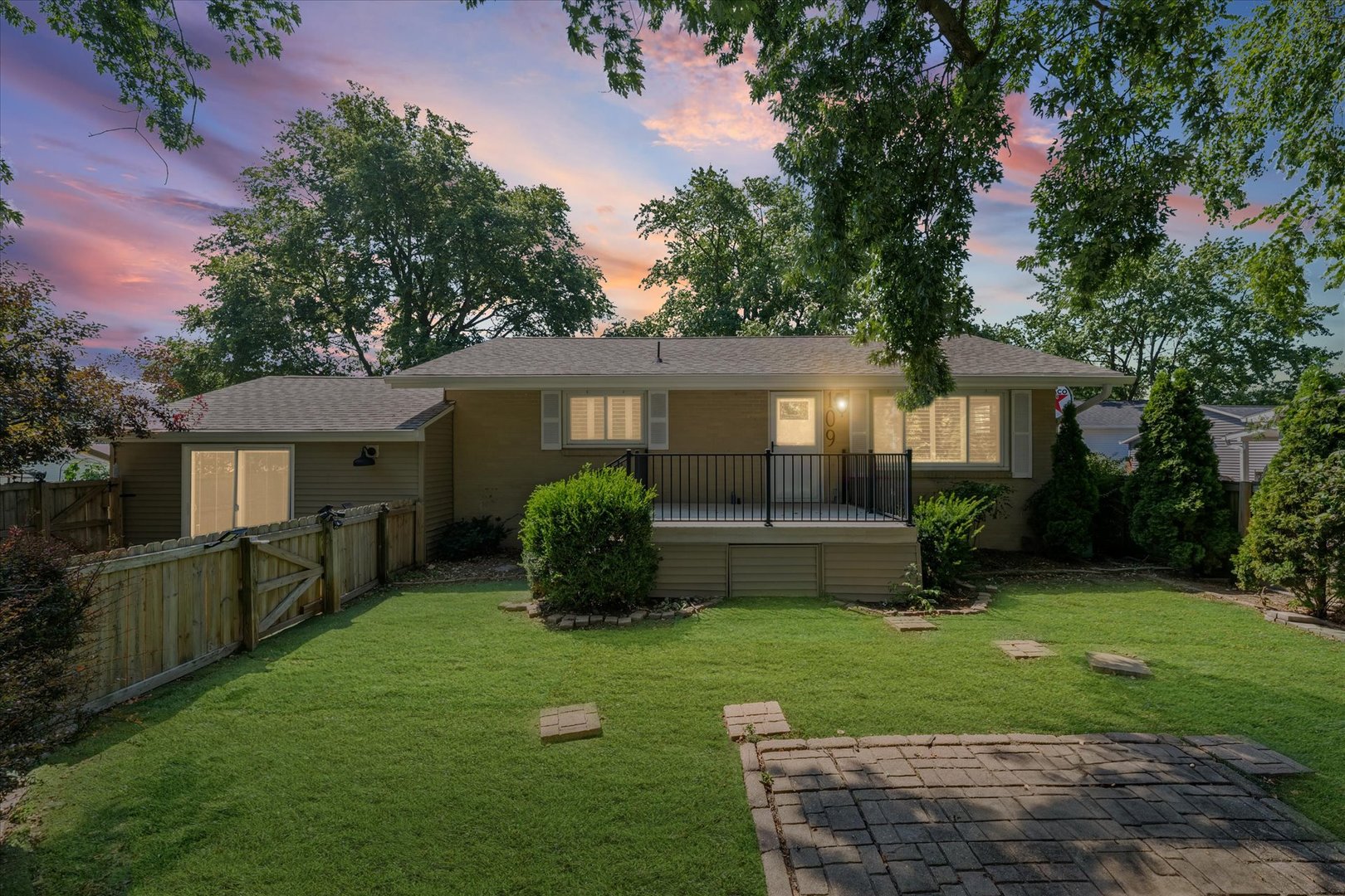 a front view of a house with a yard and porch
