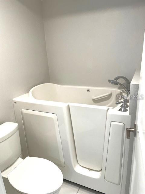 1 Boca Ciega Point Boulevard, Unit 115 St. Petersburg, FL 33708 - Photo 22 of 35 a bathroom with a toilet and a mirror