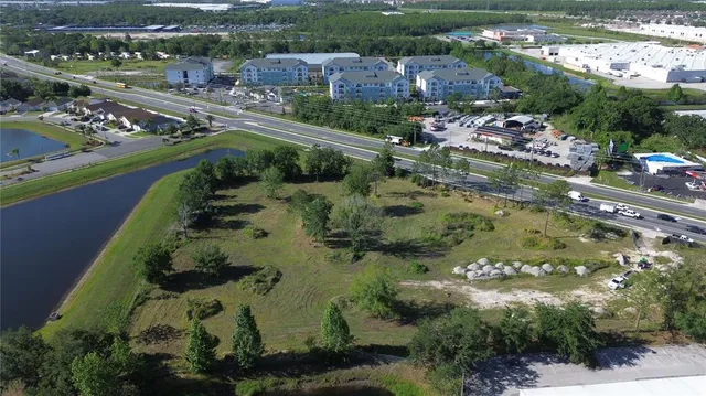 an aerial view of residential houses with outdoor space and river