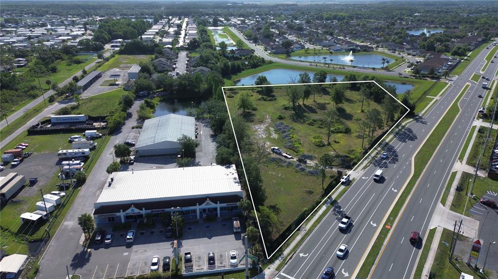 6347 Narcoossee Road Orlando, FL 32822 - Photo 16 of 17 an aerial view of a house with a yard