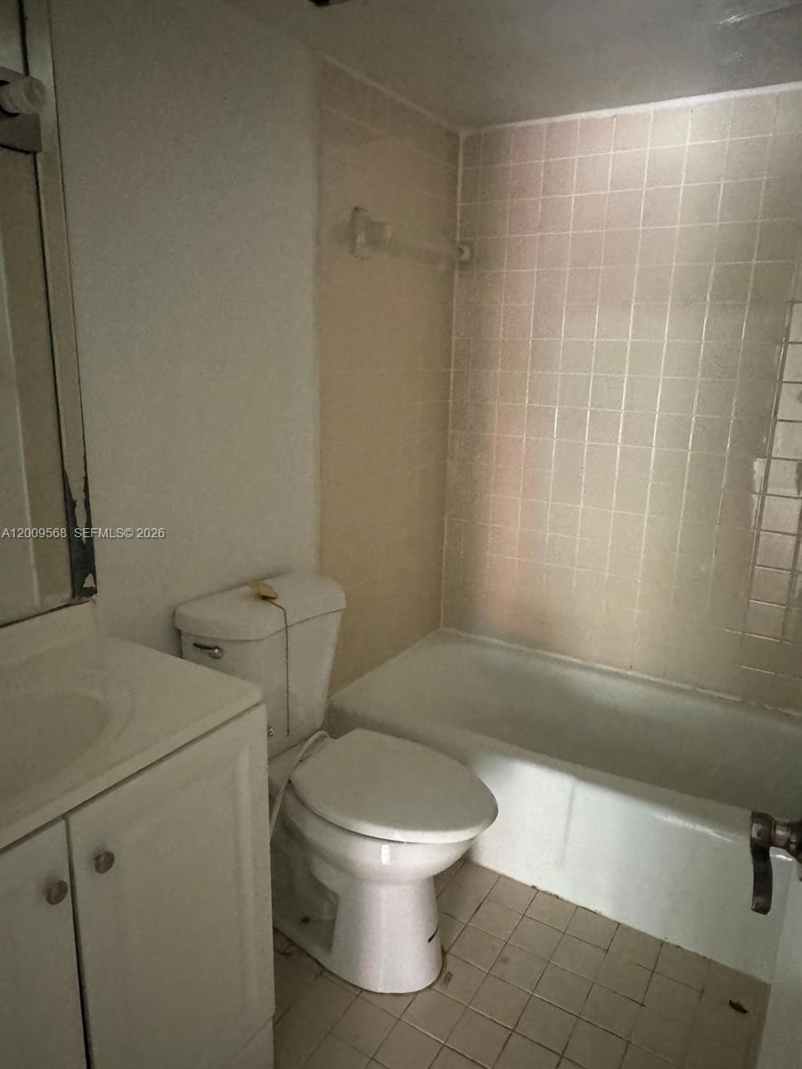 18111 Northwest 68th Avenue, Unit F106 Hialeah, FL 33015 - Photo 2 of 10 a white toilet sitting next to a bath tub