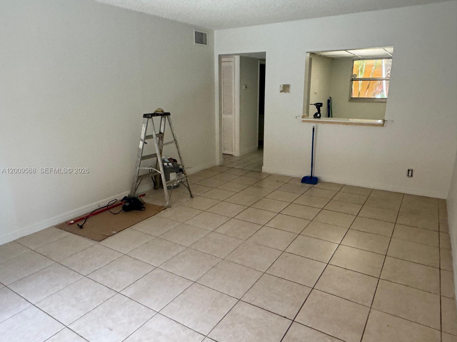 18111 Northwest 68th Avenue, Unit F106 Hialeah, FL 33015 - Photo 4 of 10 a view of a room with gym equipment