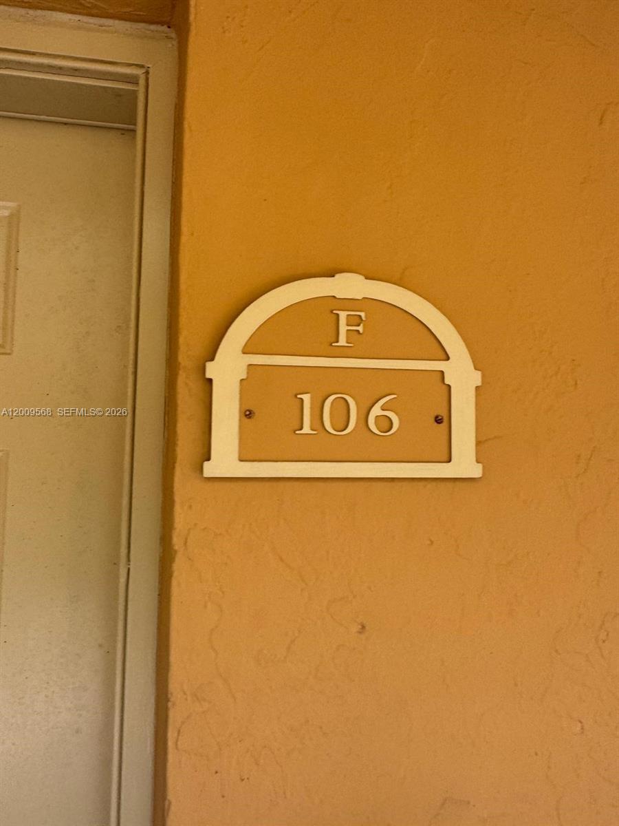 18111 Northwest 68th Avenue, Unit F106 Hialeah, FL 33015 - Photo 8 of 10 a close up of a wall with a door