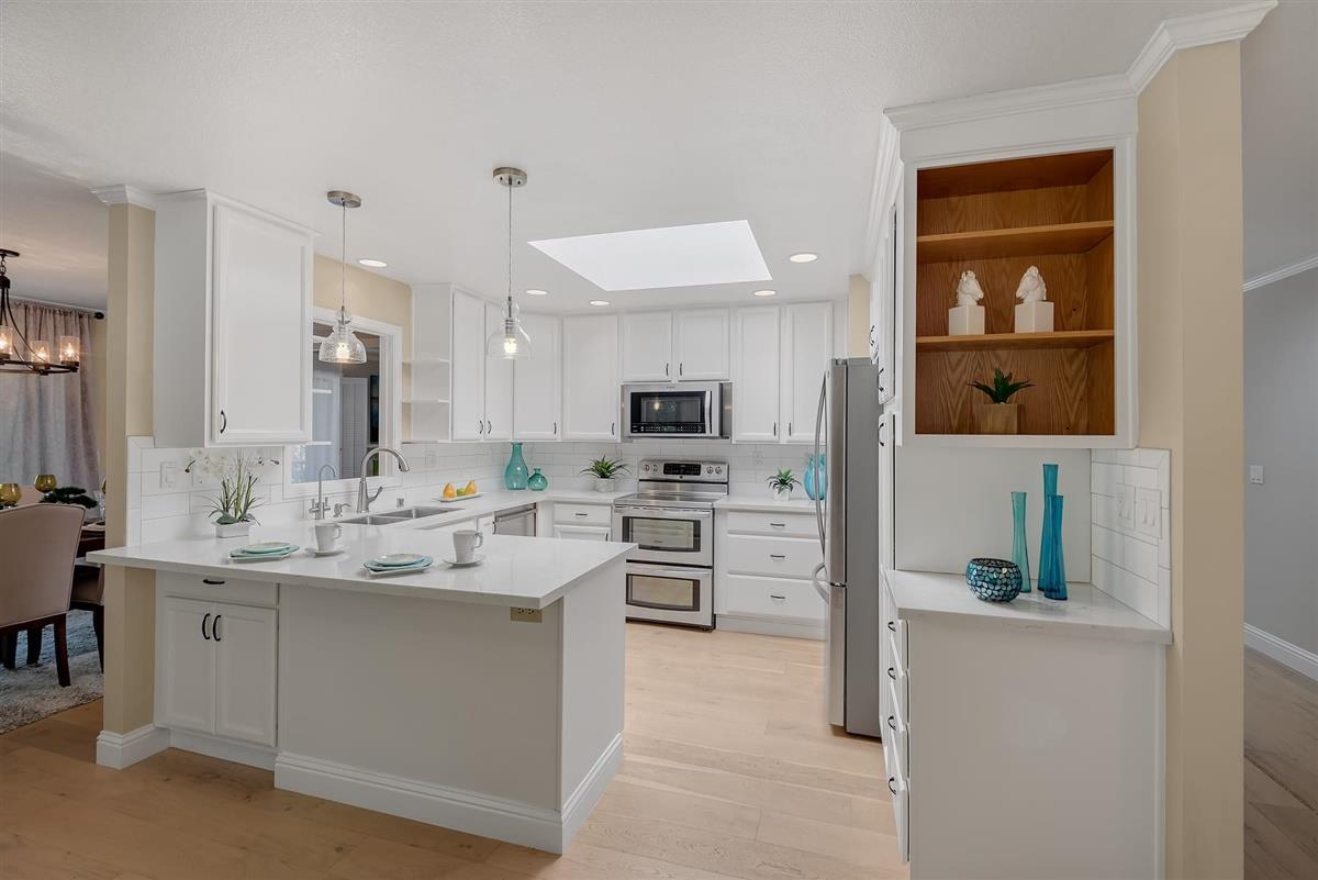 23030 Stonebridge Cupertino, CA 95014 - Photo 11 of 26 a kitchen with a sink stainless steel appliances and cabinets