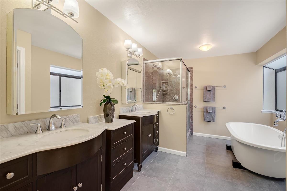 23030 Stonebridge Cupertino, CA 95014 - Photo 17 of 26 a bathroom with a double vanity sink a mirror and a toilet