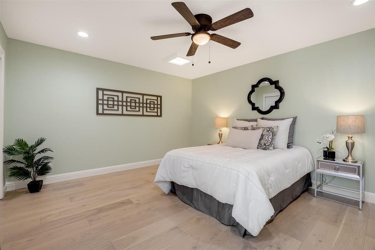 23030 Stonebridge Cupertino, CA 95014 - Photo 19 of 26 a bedroom with a bed and a chandelier