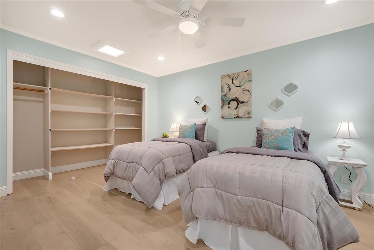 23030 Stonebridge Cupertino, CA 95014 - Photo 21 of 26 a spacious bedroom with two bed and a window