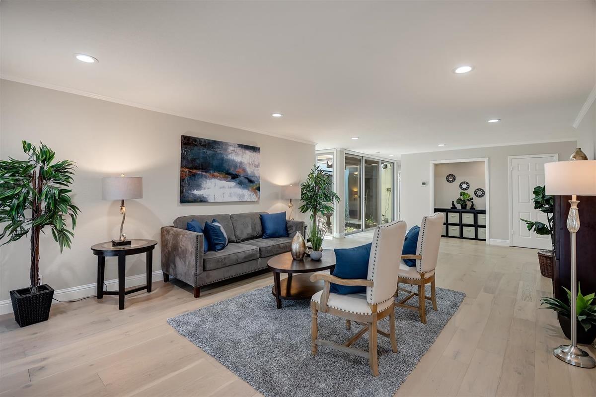 23030 Stonebridge Cupertino, CA 95014 - Photo 3 of 26 a living room with furniture and a potted plant