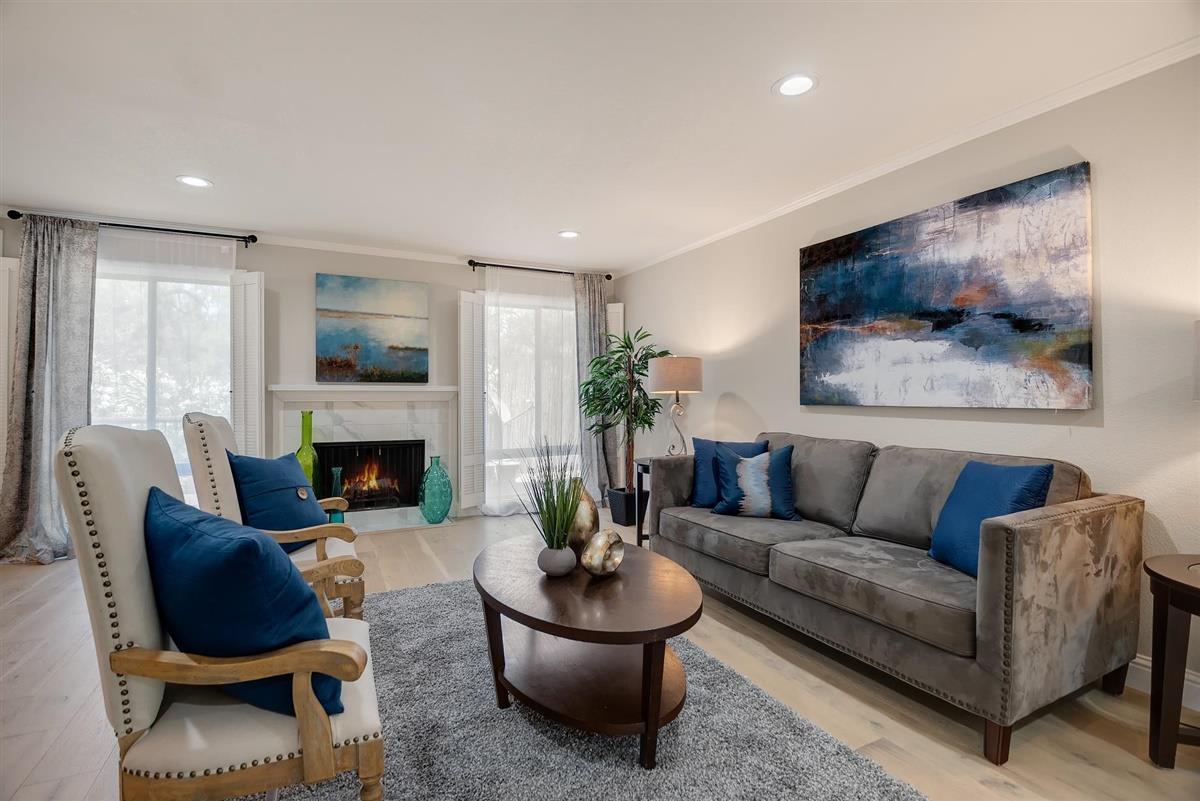 23030 Stonebridge Cupertino, CA 95014 - Photo 4 of 26 a living room with furniture a window and a fireplace