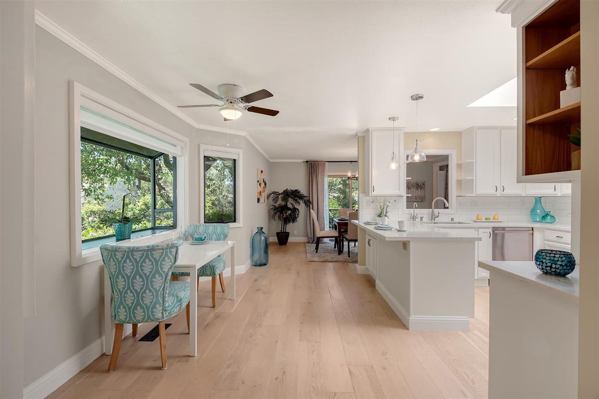 23030 Stonebridge Cupertino, CA 95014 - Photo 9 of 26 a living room with furniture a fireplace and a large window