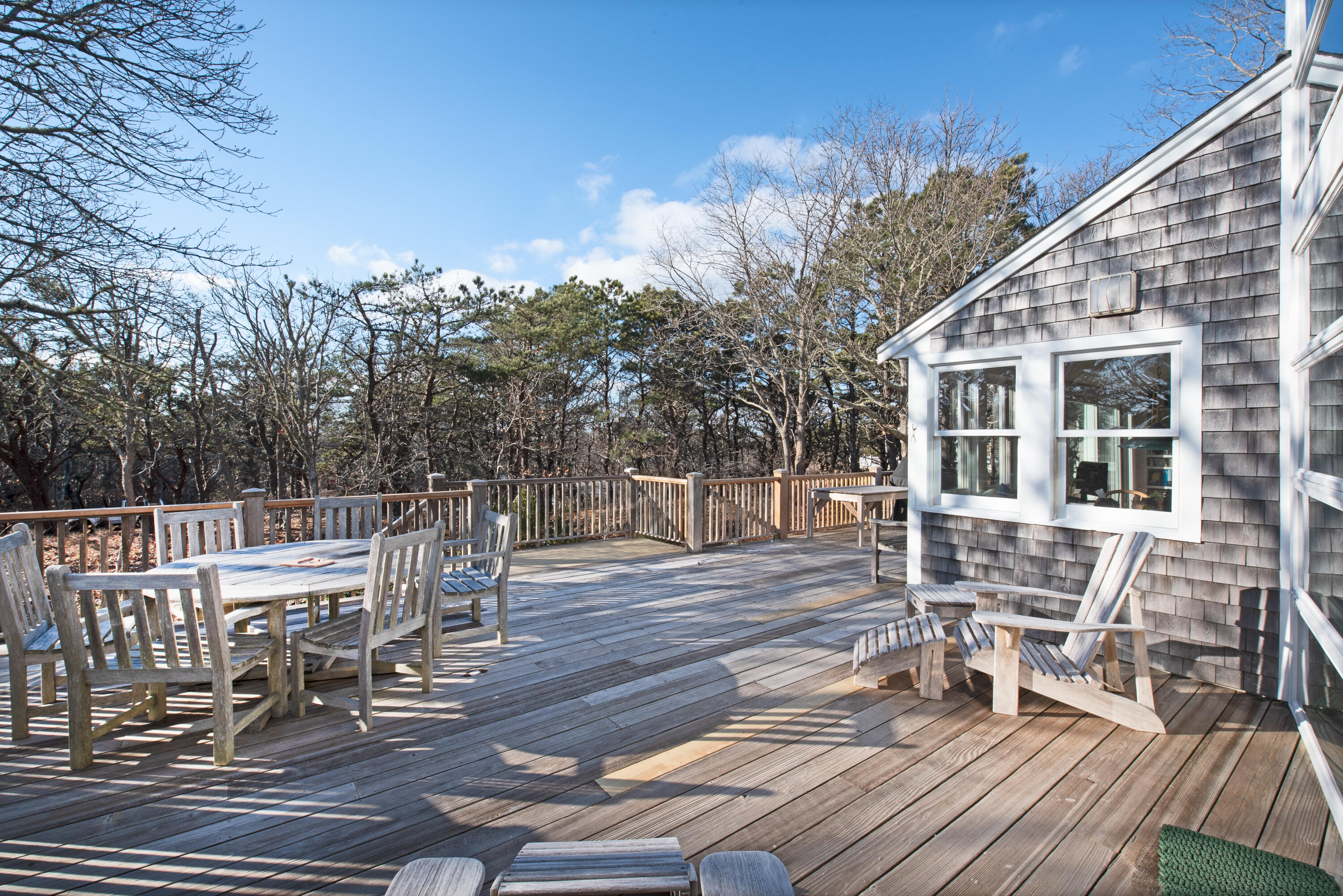 80 Shurtleff Road Eastham, MA 02642 - Photo 7 of 34 a view of a patio with table and chairs with wooden floor and fence