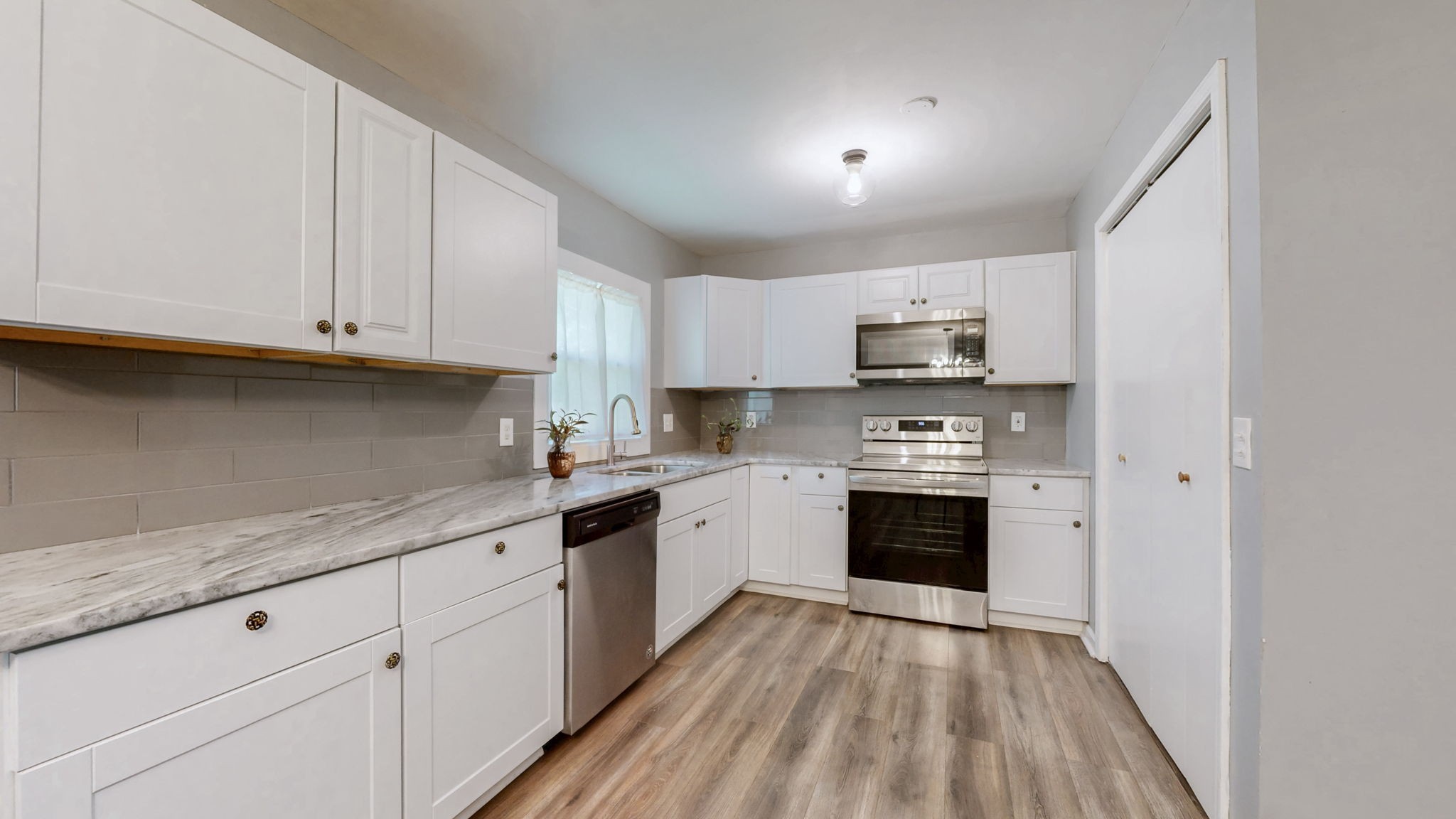 1214 Rutherford Street Murfreesboro, TN 37130 - Photo 11 of 37 a kitchen with granite countertop white cabinets and stainless steel appliances