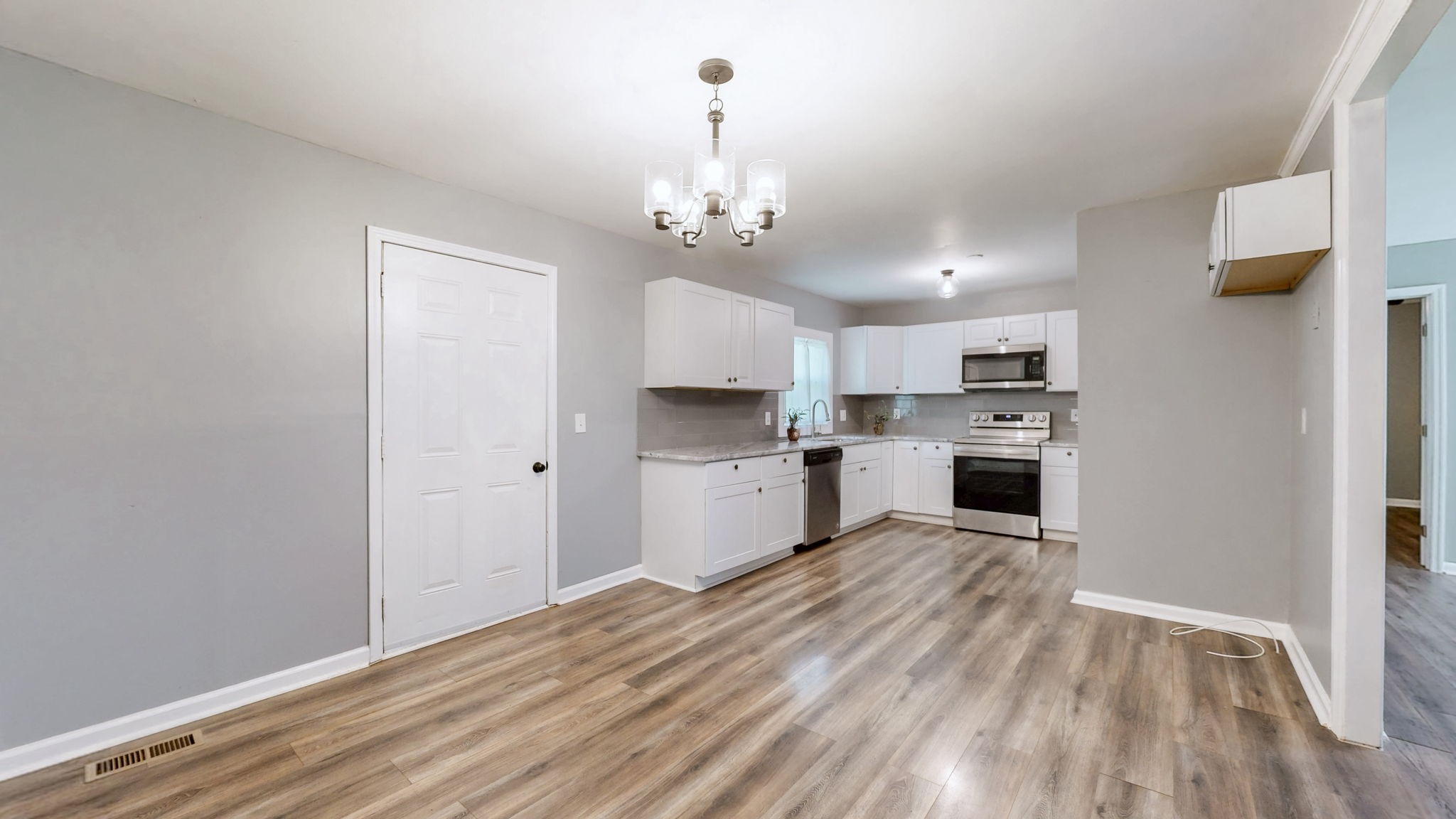 1214 Rutherford Street Murfreesboro, TN 37130 - Photo 12 of 37 a large kitchen with granite countertop a stove top oven a sink dishwasher and a refrigerator with wooden floor