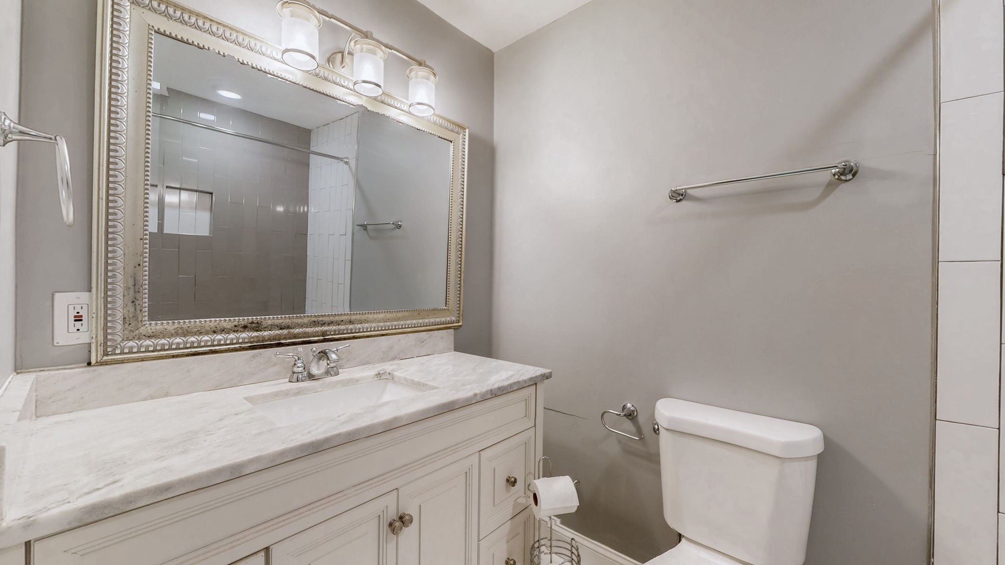 1214 Rutherford Street Murfreesboro, TN 37130 - Photo 16 of 37 a bathroom with a sink a toilet a mirror and shower